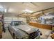 Well-organized garage featuring a classic car, workbench, and ample storage at 625 Hatchwood Dr, Haines City, FL 33844