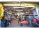 Garage with a variety of yard tools and equipment, including a riding lawn mower at 625 Hatchwood Dr, Haines City, FL 33844
