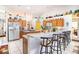 Bright kitchen features white tile flooring, a breakfast bar, and wooden cabinets at 625 Hatchwood Dr, Haines City, FL 33844