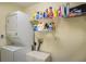 Efficient laundry room with stacked washer and dryer and shelving at 625 Hatchwood Dr, Haines City, FL 33844