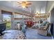 Open-concept living area with a ceiling fan, tile floors, and large windows providing ample natural light at 625 Hatchwood Dr, Haines City, FL 33844