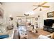 Bright living room features a comfortable recliner, sliding glass doors to the lanai, and neutral decor at 625 Hatchwood Dr, Haines City, FL 33844
