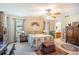 Cozy bedroom with vintage furniture, floral accents, and ceiling fan at 625 Hatchwood Dr, Haines City, FL 33844