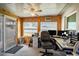 Enclosed porch office space featuring wood paneled walls and windows offering lots of natural light at 625 Hatchwood Dr, Haines City, FL 33844