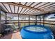 Outdoor covered patio with an above ground pool and seating area for relaxing at 625 Hatchwood Dr, Haines City, FL 33844