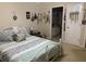 Comfortable bedroom with a white metal frame bed, blue accents, and a view into the en suite bathroom at 703 Eagle Pond Dr # 703, Winter Haven, FL 33884