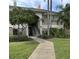 Inviting condo exterior with lush landscaping and a charming walkway leading to the entrance at 703 Eagle Pond Dr # 703, Winter Haven, FL 33884