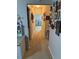 Neutral hallway with beige carpet, warm lighting and decorative wall art, connecting various rooms in the home at 703 Eagle Pond Dr # 703, Winter Haven, FL 33884