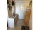 This hallway has plenty of storage and laundry capabilities with a view into the kitchen at 703 Eagle Pond Dr # 703, Winter Haven, FL 33884