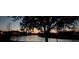 Enjoy this condo's water views at sunset with a view of nearby neighborhood homes at 703 Eagle Pond Dr # 703, Winter Haven, FL 33884