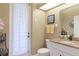 Bathroom featuring a single vanity with granite countertop and a shower with decorative curtains at 7327 Bent Grass Dr, Winter Haven, FL 33884