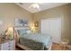 Cozy bedroom featuring floral bedding, whitewashed wood furniture and neutral wall color at 7327 Bent Grass Dr, Winter Haven, FL 33884