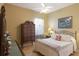 Bedroom with traditional decor, including a patterned bedspread and wooden dresser at 7327 Bent Grass Dr, Winter Haven, FL 33884
