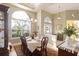 Formal dining room with large window and seating for eight at 7327 Bent Grass Dr, Winter Haven, FL 33884