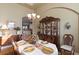 Elegant dining room with china cabinet and seating for six at 7327 Bent Grass Dr, Winter Haven, FL 33884