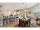 Well-lit dining area with seating for six, adjacent to modern kitchen at 7327 Bent Grass Dr, Winter Haven, FL 33884