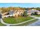 Well-maintained single-story home featuring a pristine lawn, mature trees, and a two-car garage at 7327 Bent Grass Dr, Winter Haven, FL 33884