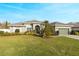 Charming home boasts manicured landscaping, arched windows, and a spacious front lawn, creating curb appeal at 7327 Bent Grass Dr, Winter Haven, FL 33884