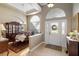 Elegant foyer with tile flooring, arched transom window and a view into the formal dining room at 7327 Bent Grass Dr, Winter Haven, FL 33884