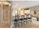 Modern kitchen featuring a breakfast bar with four chairs and open floor plan at 7327 Bent Grass Dr, Winter Haven, FL 33884