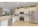 Bright kitchen with stainless steel appliances, white cabinets, and an open layout design for entertaining at 7327 Bent Grass Dr, Winter Haven, FL 33884