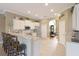 Spacious kitchen featuring white cabinetry, stainless steel appliances, and a breakfast bar with seating at 7327 Bent Grass Dr, Winter Haven, FL 33884