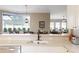Bright kitchen featuring a breakfast bar overlooking the dining area and stainless steel appliances at 7327 Bent Grass Dr, Winter Haven, FL 33884