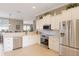 Bright kitchen with stainless steel appliances, white cabinetry, and tile backsplash at 7327 Bent Grass Dr, Winter Haven, FL 33884