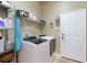Laundry room with newer front load washer and dryer and wire rack shelving at 7327 Bent Grass Dr, Winter Haven, FL 33884