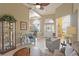 Open living area with tile floors, high ceilings, and a view of the dining room and front entry at 7327 Bent Grass Dr, Winter Haven, FL 33884
