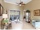 Bright living room featuring neutral colors, tile flooring, and sliding glass doors to a screened lanai at 7327 Bent Grass Dr, Winter Haven, FL 33884