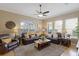 Comfortable living room with plush seating, ceiling fan, and large windows at 7327 Bent Grass Dr, Winter Haven, FL 33884
