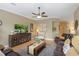 Spacious living room with large TV, ceiling fan, and comfortable seating at 7327 Bent Grass Dr, Winter Haven, FL 33884