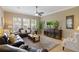 Cozy living room featuring a ceiling fan, TV, and ample natural light at 7327 Bent Grass Dr, Winter Haven, FL 33884