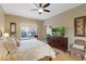 Spacious main bedroom with a king bed, fan, and a view to the backyard at 7327 Bent Grass Dr, Winter Haven, FL 33884