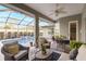 Screened patio with in-ground pool, dining table, and comfortable seating for entertaining at 7327 Bent Grass Dr, Winter Haven, FL 33884