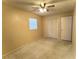 Bedroom with ceiling fan, neutral colored walls, and double door closet at 909 Spirit Lake Rd, Winter Haven, FL 33880