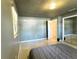 Bedroom with light grey walls, ceiling fan, and mirrored sliding door closet at 909 Spirit Lake Rd, Winter Haven, FL 33880
