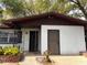 Close-up of the front entrance with security bars, a brown door, and plants at 909 Spirit Lake Rd, Winter Haven, FL 33880