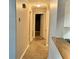 Hallway with laminate wood flooring, light tan walls, and white trim at 909 Spirit Lake Rd, Winter Haven, FL 33880