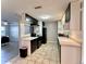 Modern kitchen with sleek black and white cabinets and tile flooring, offering a clean design at 909 Spirit Lake Rd, Winter Haven, FL 33880