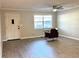 Cozy living room featuring laminate flooring, a ceiling fan, and a door at 909 Spirit Lake Rd, Winter Haven, FL 33880