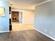 Open living room featuring wood floors, with the kitchen and fireplace visible at 909 Spirit Lake Rd, Winter Haven, FL 33880