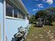 A view of the backyard from the side of the house showing a shed at 915 Exmoor Way, Lake Wales, FL 33853