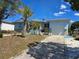 Charming single-story home with a well-manicured front yard, garage, palm trees, and inviting entryway at 915 Exmoor Way, Lake Wales, FL 33853