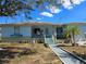 Charming single-story home featuring a well-manicured front yard and inviting entryway with steps and landscaping at 915 Exmoor Way, Lake Wales, FL 33853