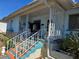 Charming blue home with a cozy front porch and decorative white railing at 915 Exmoor Way, Lake Wales, FL 33853
