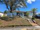 Charming single-story home with a quaint front porch and mature landscaping at 915 Exmoor Way, Lake Wales, FL 33853