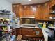 Functional kitchen with wooden cabinets, a cooktop, and essential appliances at 915 Exmoor Way, Lake Wales, FL 33853