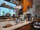 Traditional kitchen featuring a white porcelain sink, wooden cabinets and tiled backsplash with modern appliances at 915 Exmoor Way, Lake Wales, FL 33853
